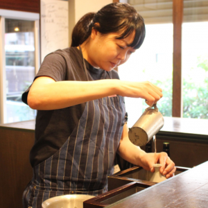 Marie Chiba is pouring sake to tokkuri for serving kanzake